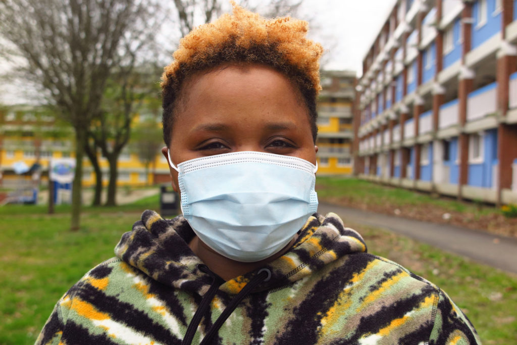 Black woman with short hair wearing and mask